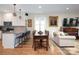 Open concept dining area with wood floors and seating for six at 42610 Moonshine Dr, New London, NC 28127