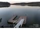 Private dock with multiple platforms and steps leading to the lake at 42610 Moonshine Dr, New London, NC 28127