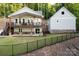 Stunning two-story home featuring a spacious porch with ceiling fans and lush landscaping at 42610 Moonshine Dr, New London, NC 28127