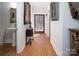 Bright hallway with hardwood floors and elegant artwork at 42610 Moonshine Dr, New London, NC 28127