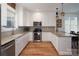 Spacious kitchen with white cabinets, granite countertops, and stainless steel appliances at 42610 Moonshine Dr, New London, NC 28127