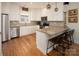 Modern kitchen featuring white cabinets, granite counters, and hardwood floors at 42610 Moonshine Dr, New London, NC 28127