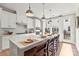 Modern kitchen with white cabinets, island, and stainless steel appliances at 5033 Westmead Ln, Charlotte, NC 28262