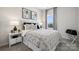 Comfortable bedroom features neutral decor, a large window, and stylish furnishings, creating a relaxing retreat at 5037 Westmead Ln, Charlotte, NC 28262