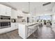 Modern kitchen boasts an island, stainless steel appliances, and seamless flow to the living area at 5037 Westmead Ln, Charlotte, NC 28262