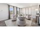 Cozy sitting area with modern chairs, patterned rug, and natural light from large windows at 5037 Westmead Ln, Charlotte, NC 28262