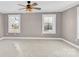 Large bedroom with two windows, ceiling fan, and neutral walls at 550 Woodleaf Barber Rd, Cleveland, NC 27013