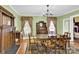 Light and airy dining room with antique furnishings at 550 Woodleaf Barber Rd, Cleveland, NC 27013