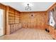 Dining room or den with wood paneling, built-in shelving, and hardwood floors at 550 Woodleaf Barber Rd, Cleveland, NC 27013