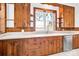 Kitchen features wood cabinets, white countertops, and a large window with a view at 550 Woodleaf Barber Rd, Cleveland, NC 27013