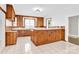 Kitchen with wood cabinets, island, and white tile floor at 550 Woodleaf Barber Rd, Cleveland, NC 27013
