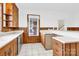 Classic kitchen with wood cabinets, white countertops, and a window overlooking the backyard at 550 Woodleaf Barber Rd, Cleveland, NC 27013