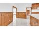 View of kitchen with wood paneling, tiled floor, and a glimpse of another room at 550 Woodleaf Barber Rd, Cleveland, NC 27013