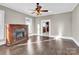 Living room with hardwood floors, fireplace, and ceiling fan at 550 Woodleaf Barber Rd, Cleveland, NC 27013