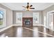 Bright living room features hardwood floors, fireplace, and large windows at 550 Woodleaf Barber Rd, Cleveland, NC 27013