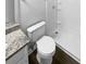 Clean bathroom with white toilet and bathtub, and granite countertop at 6041 Pinebark Ct, Charlotte, NC 28212