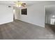 Spacious bedroom with carpeted floor, ceiling fan, and access to hallway at 6041 Pinebark Ct, Charlotte, NC 28212