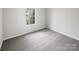 Spacious bedroom with grey carpet and large window at 6041 Pinebark Ct, Charlotte, NC 28212