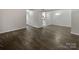 Open concept dining area with dark gray vinyl flooring at 6041 Pinebark Ct, Charlotte, NC 28212