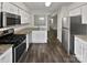 Kitchen with granite countertops, white cabinets, and stainless steel appliances at 6041 Pinebark Ct, Charlotte, NC 28212