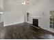 Spacious living room featuring dark gray vinyl flooring and a fireplace at 6041 Pinebark Ct, Charlotte, NC 28212