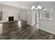 Bright living room with fireplace and wood-look floors at 6041 Pinebark Ct, Charlotte, NC 28212