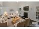 Virtually staged living room with fireplace and neutral decor at 6041 Pinebark Ct, Charlotte, NC 28212