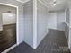Covered porch with grey painted walls and dark grey wood flooring at 6041 Pinebark Ct, Charlotte, NC 28212