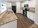 Modern kitchen with granite countertops and black appliances at 8131 Paw Club Dr, Charlotte, NC 28214