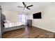 Bedroom with a gray upholstered bed and wood floors at 9323 John Russell Rd, Charlotte, NC 28215