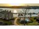 Beautiful aerial view of condo community with pool, lake access, and boat docks at sunset at 9801 Emerald Point Dr # 2, Charlotte, NC 28278
