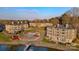 Aerial view of waterfront condos, swimming pool, and boat docks with lake access in a landscaped community at 9801 Emerald Point Dr # 2, Charlotte, NC 28278