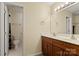 Bathroom featuring double sinks with wood cabinets, a large mirror, and a separate toilet and shower room at 9801 Emerald Point Dr # 2, Charlotte, NC 28278