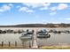 Waterfront boat slip with multiple boats docked at the pier and view of the lake and horizon beyond at 9801 Emerald Point Dr # 2, Charlotte, NC 28278