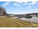 Scenic view of a lake, boat dock and waterfront building with green grass on a clear, partially cloudy day at 9801 Emerald Point Dr # 2, Charlotte, NC 28278
