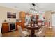 Open-concept kitchen with a wine fridge, stainless steel appliances, hardwood floors, and a dining table at 9801 Emerald Point Dr # 2, Charlotte, NC 28278