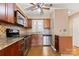 Kitchen featuring stainless steel appliances, granite countertops, wood cabinets, and tile backsplash at 9801 Emerald Point Dr # 2, Charlotte, NC 28278