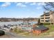 Scenic lake view featuring a pool, boat docks, and multi-story buildings in a serene setting at 9801 Emerald Point Dr # 2, Charlotte, NC 28278
