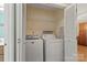 Functional laundry room with a washer and dryer, storage shelves and light colored walls at 9801 Emerald Point Dr # 2, Charlotte, NC 28278