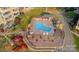 Aerial view of the waterfront condo community showing a pool with tables and chairs nearby at 9801 Emerald Point Dr # 2, Charlotte, NC 28278