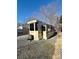 Tan Retreat RV with covered patio and gravel area at 106 Hummingbird Cir, New London, NC 27281