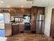 Modern kitchen with wood cabinets and appliances at 106 Hummingbird Cir, New London, NC 27281