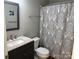 Stylish bathroom featuring updated vanity with marble top and decorative shower curtain at 11121 S Harrowfield Rd, Charlotte, NC 28226