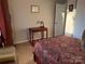 Bright bedroom includes a desk, comfortable carpet, and a decorative comforter at 11121 S Harrowfield Rd, Charlotte, NC 28226
