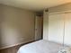 Neutral bedroom with sliding closet doors and ensuite access at 11121 S Harrowfield Rd, Charlotte, NC 28226