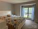 Bright bedroom with large window and stylish, colorful bedding at 11121 S Harrowfield Rd, Charlotte, NC 28226