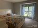 Bright bedroom with large window and stylish, colorful bedding at 11121 S Harrowfield Rd, Charlotte, NC 28226