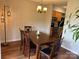 Inviting dining room featuring hardwood floors, modern lighting and a dark wood table at 11121 S Harrowfield Rd, Charlotte, NC 28226