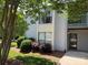 Charming two-story condo with neutral siding, mature trees, and manicured landscaping at 11121 S Harrowfield Rd, Charlotte, NC 28226