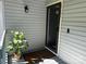 Inviting front door area with stylish light fixture, potted plant, and a welcome mat at 11121 S Harrowfield Rd, Charlotte, NC 28226